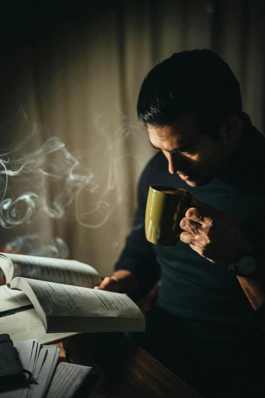 a man reading a book while holding a cup of coffee, a portrait, pexels contest winner, romanticism, smoke behind, praying, mahira khan as a d&d wizard, praying with tobacco