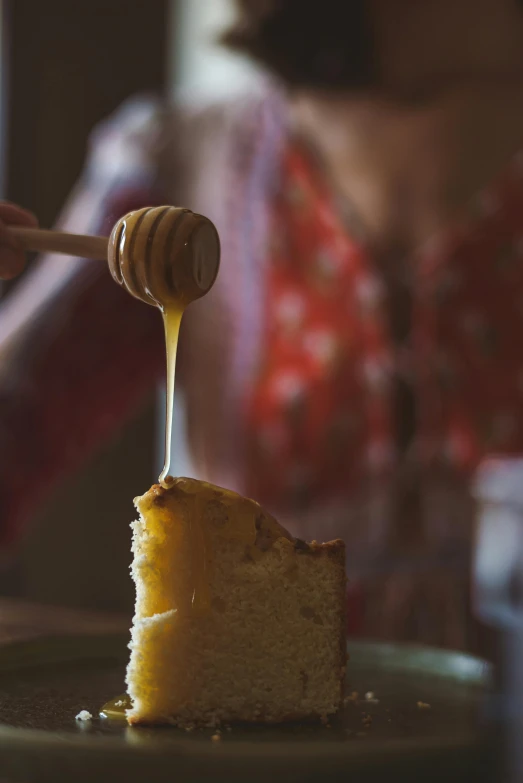 a piece of cake is being drizzled with honey, a portrait, pexels contest winner, tall thin, cozy, grainy, promo image