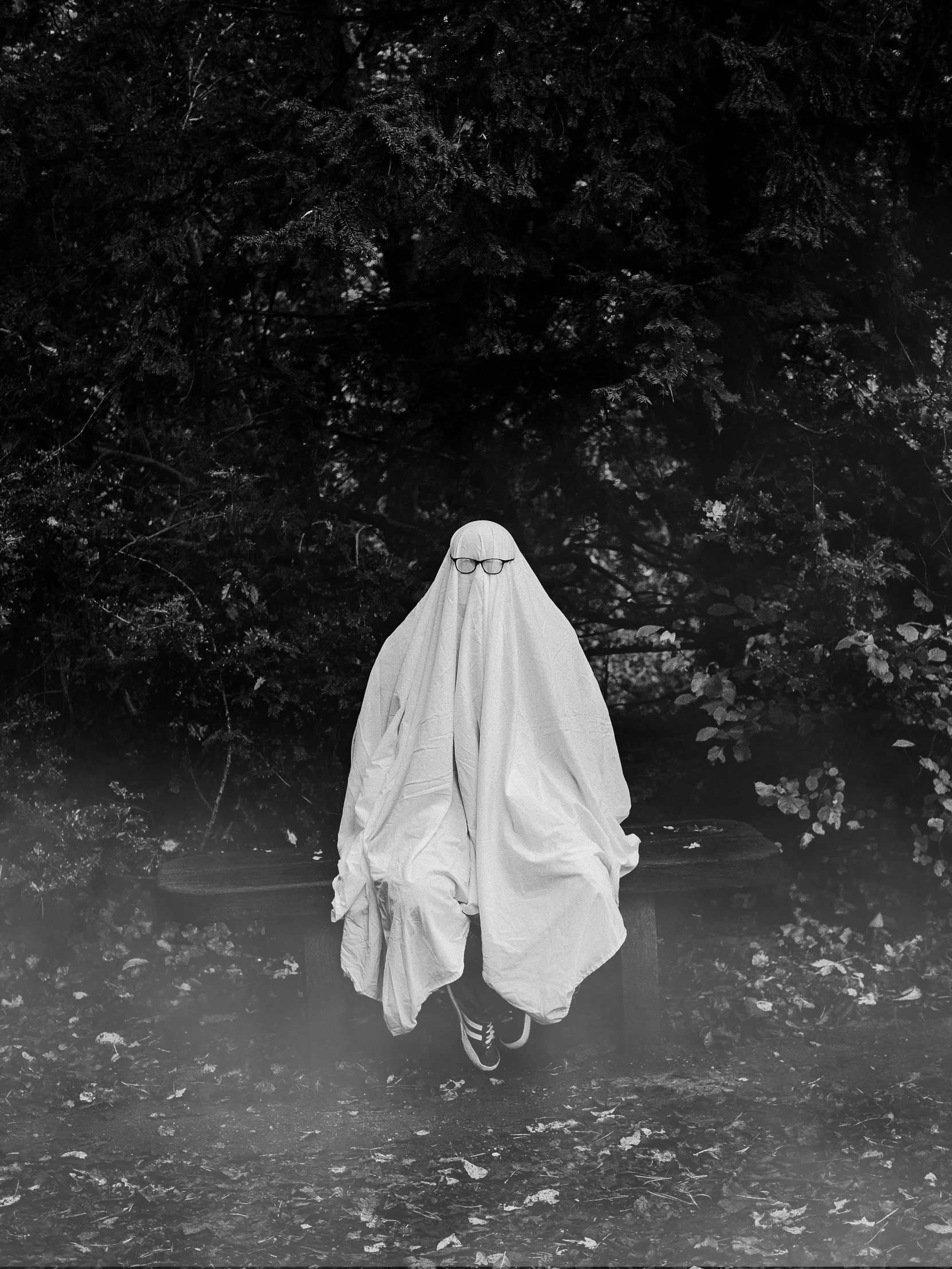 a black and white photo of a person in a ghost costume, an album cover, by Lucia Peka, unsplash, white clothes, 2 0 1 7, kacper niepokolczycki, 2019
