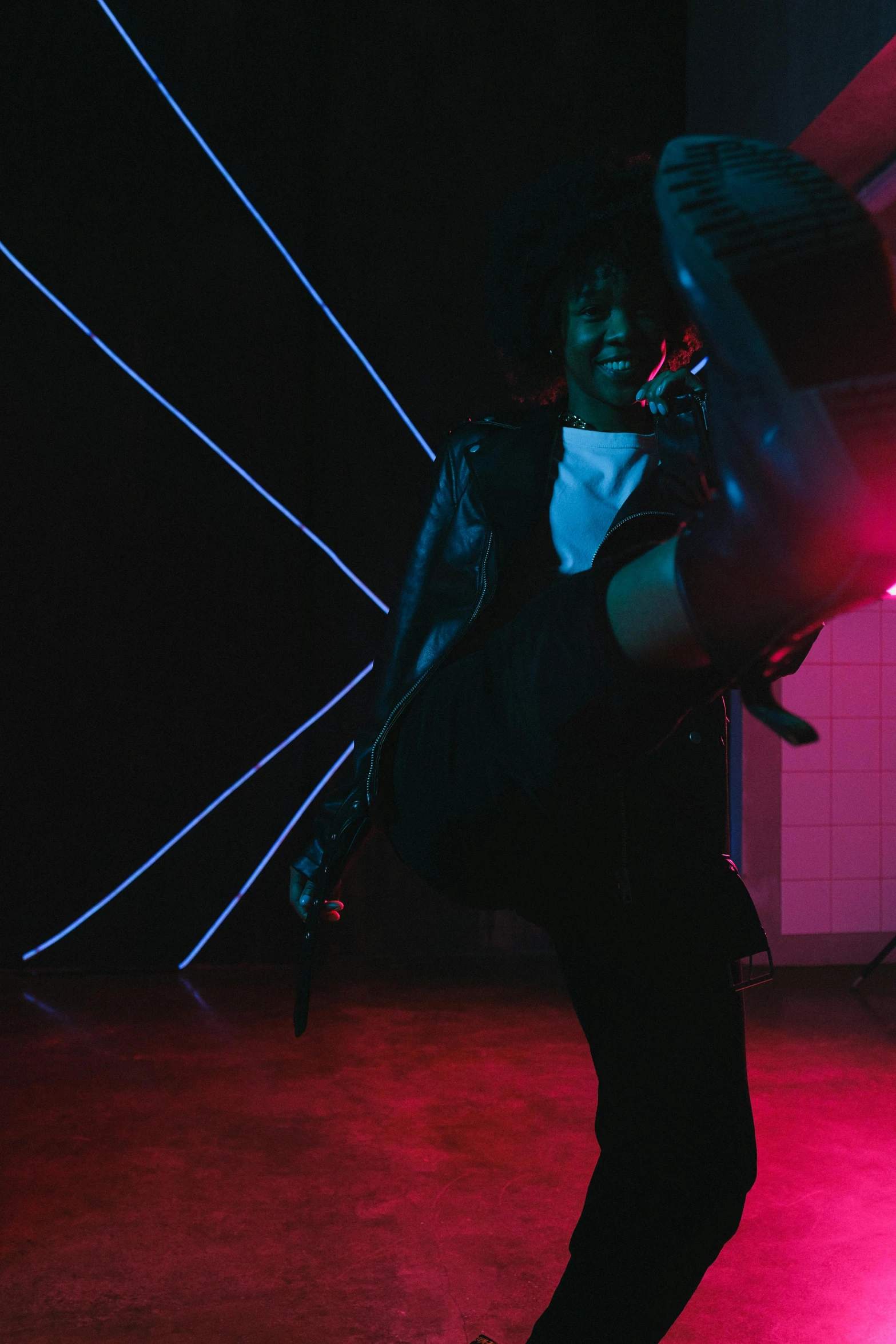 a man standing in front of a red light, an album cover, unsplash, happening, she is dancing, noire moody scene, in a nightclub, cinematic outfit photo