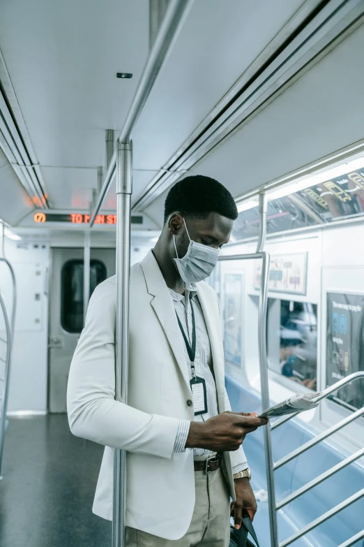 a man wearing a face mask on a subway, pexels contest winner, afrofuturism, white suit and black tie, foxish guy in a lab coat, instagram photo, carrying a tray