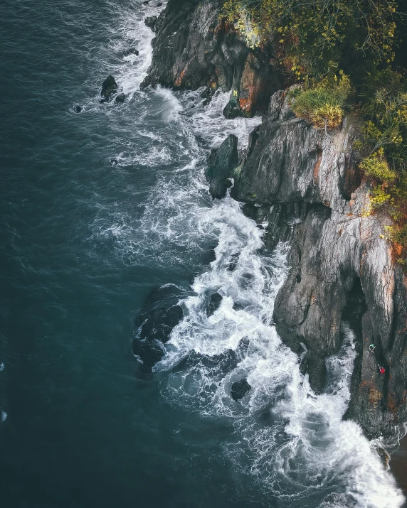 a group of people standing on top of a cliff next to the ocean, inspired by Elsa Bleda, pexels contest winner, hudson river school, rushing water, aerial photo, lush surroundings, a photo of the ocean