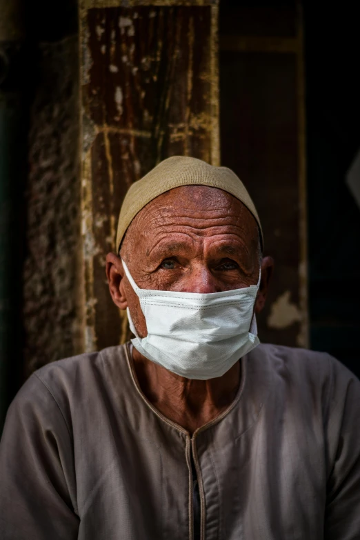 a close up of a person wearing a face mask, by Ahmed Yacoubi, head of old man, slide show, egypt, multiple stories