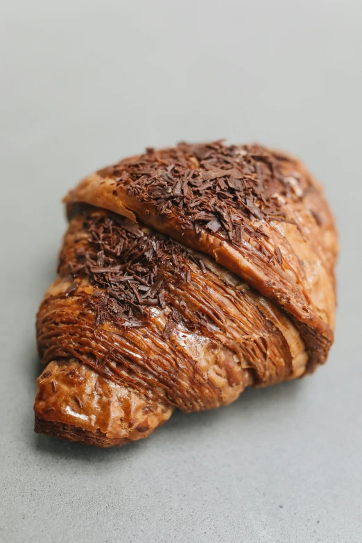 a close up of a pastry on a table, fuji choco, vine twist, 3/4 front view, fully chocolate