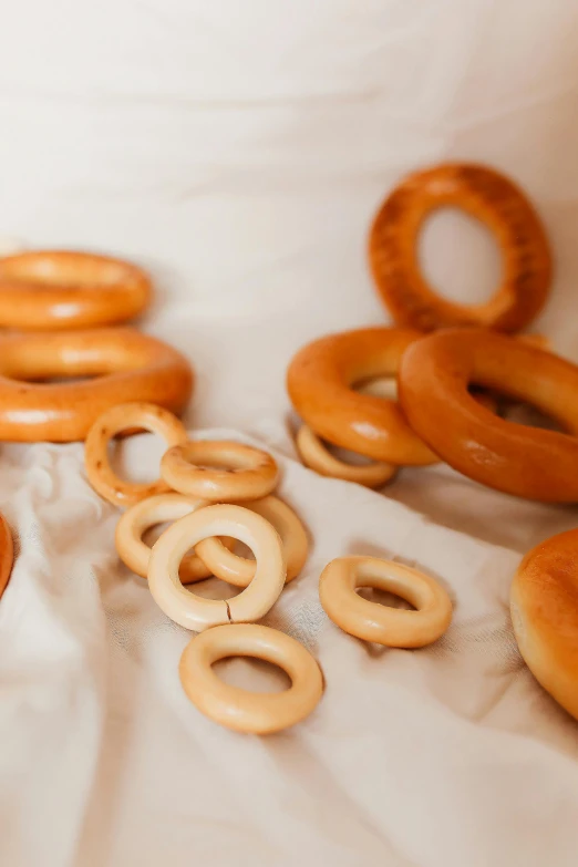 a bunch of doughnuts that are on a table, by Franz Hegi, hurufiyya, bone jewellery, natural soft rim light, traditional, looping