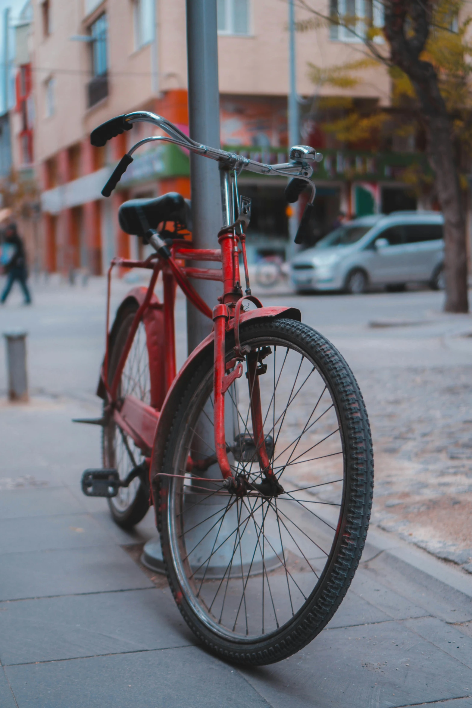 a red bike parked on the side of a street, on a street, up close, still photograph, rectangle