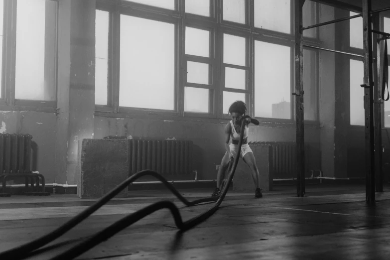 a black and white photo of a woman in a gym, bauhaus, hoses, vfx, alexey egorov, rope