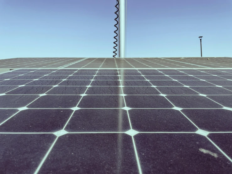 a large array of solar panels on top of a roof, an album cover, by Carey Morris, unsplash, square lines, shot from a low angle, solarised, 15081959 21121991 01012000 4k