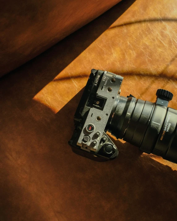 a camera sitting on top of a brown couch, unsplash contest winner, sony fx 6, looking down on the camera, megapixel, video footage