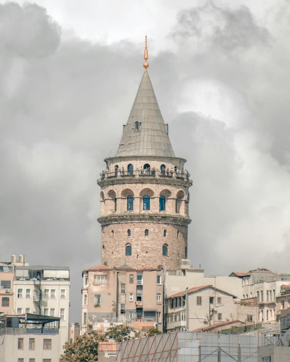a tall tower sitting in the middle of a city, inspired by Niyazi Selimoglu, pexels contest winner, art nouveau, grey, turkey, product image, museum photo