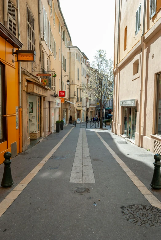 a narrow street in an old european city, by Bernard D’Andrea, trending on unsplash, monaco, square, yellow, quiet street