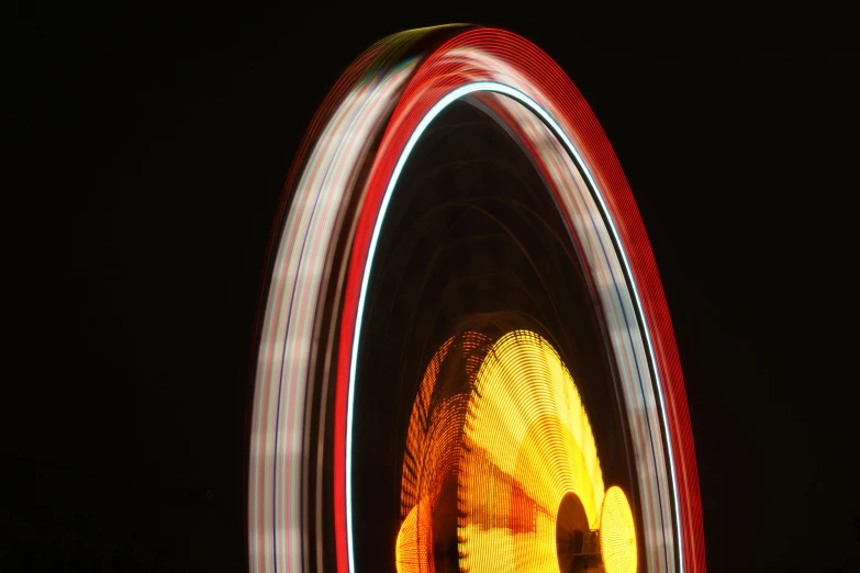 a close up of a ferris wheel at night, by Doug Ohlson, black and yellow and red scheme, spinning whirlwind, 15081959 21121991 01012000 4k, a wooden