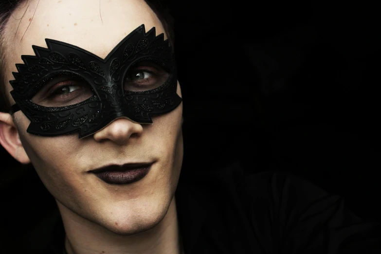 a close up of a person wearing a black mask, inspired by Bálint Kiss, pexels contest winner, androgynous male, batgirl, prideful look, non-binary