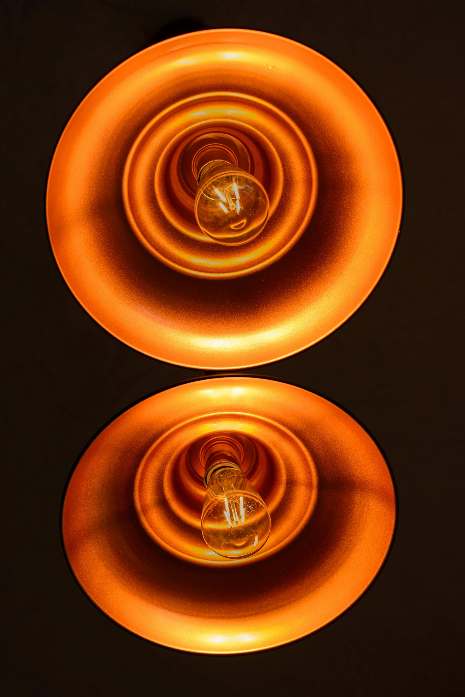 a couple of lights that are on top of a table, an album cover, inspired by Anna Füssli, kinetic art, orange extremely coherent, bottom - view, detail studio quality lighting, bulbous