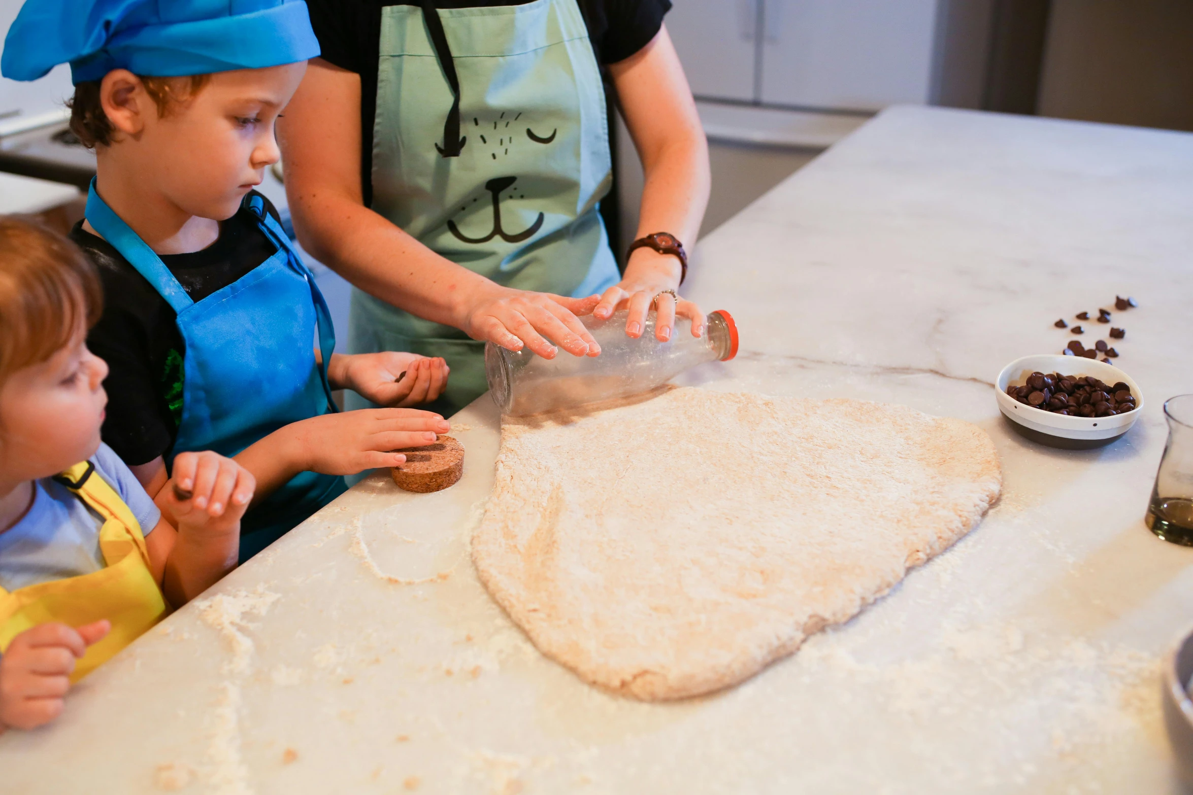 a woman and two children preparing food in a kitchen, inspired by Duccio, pexels contest winner, process art, animal - shaped bread, closeup - view, parchment, lachlan bailey
