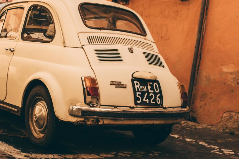 a small white car parked on a cobblestone street, pexels contest winner, renaissance, in retro colors, profile image, mozzarella, 🚿🗝📝