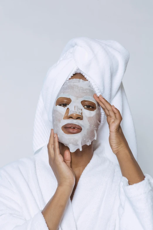 a woman putting a facial mask on her face, by Ellen Gallagher, trending on pexels, renaissance, wearing white robe, beauty campaign, detailed face face face face, natural complexion