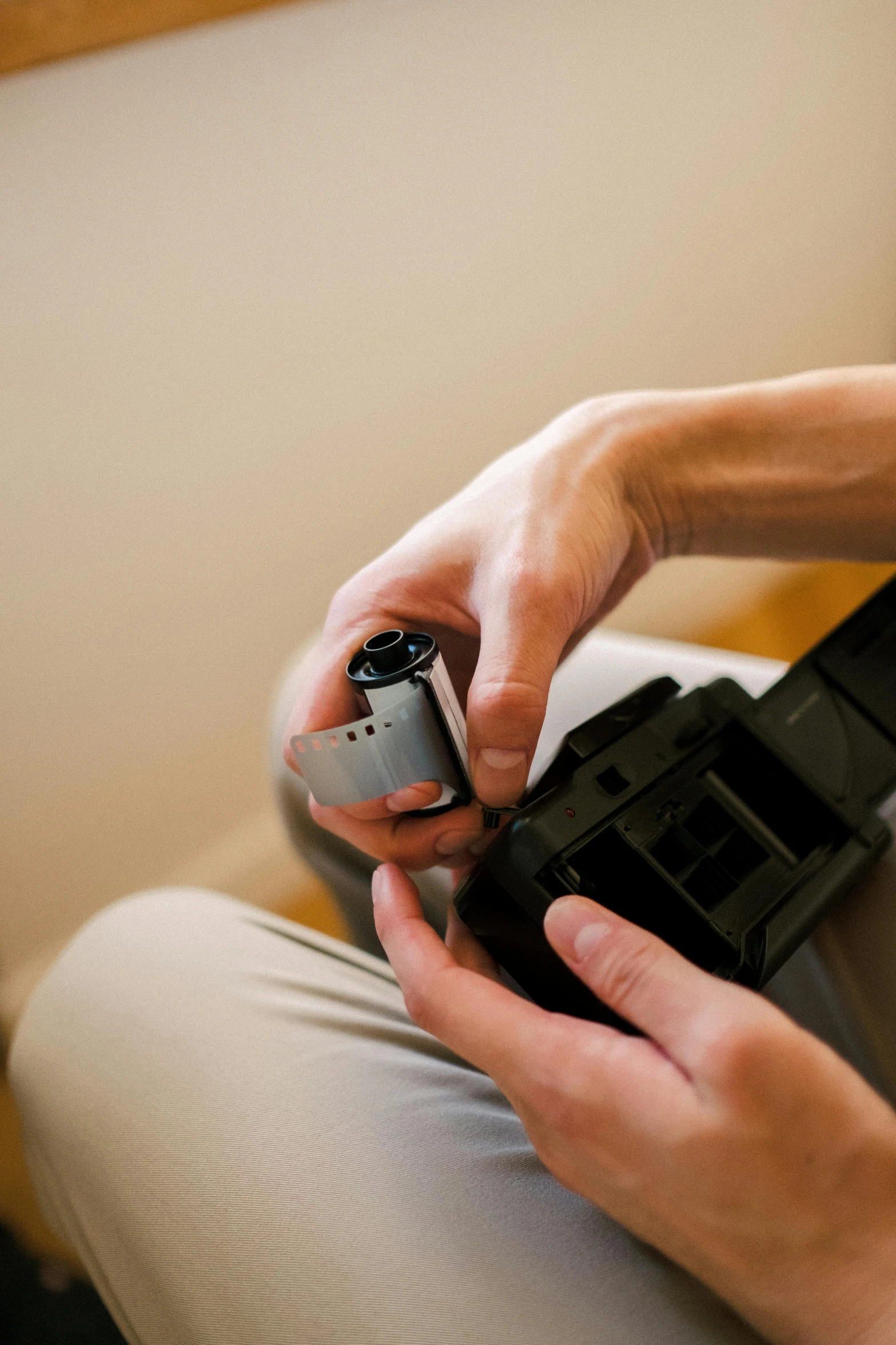 a person holding a video game controller in their hand, by Robert Medley, hasselblad camera, knee, quick assembly, to