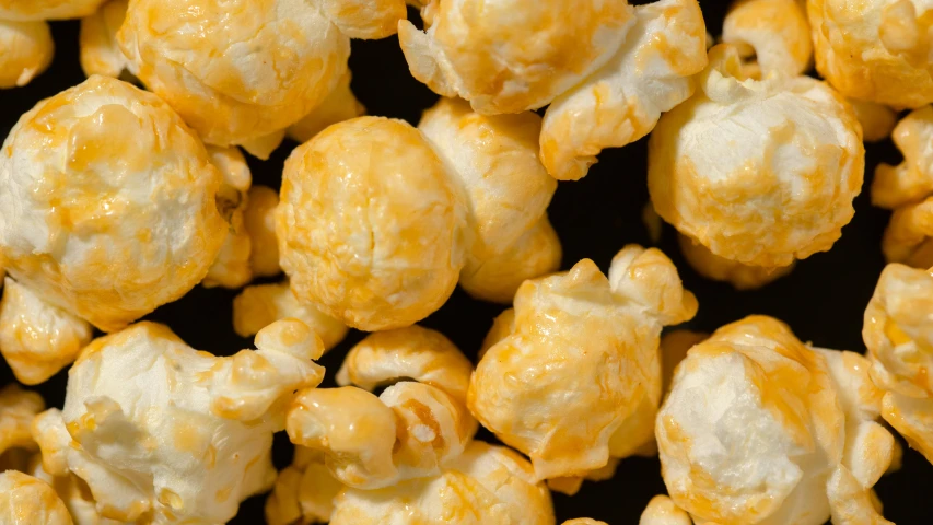 a pile of popcorn sitting on top of a table, yellow-orange, detailed product image, manuka, close up image