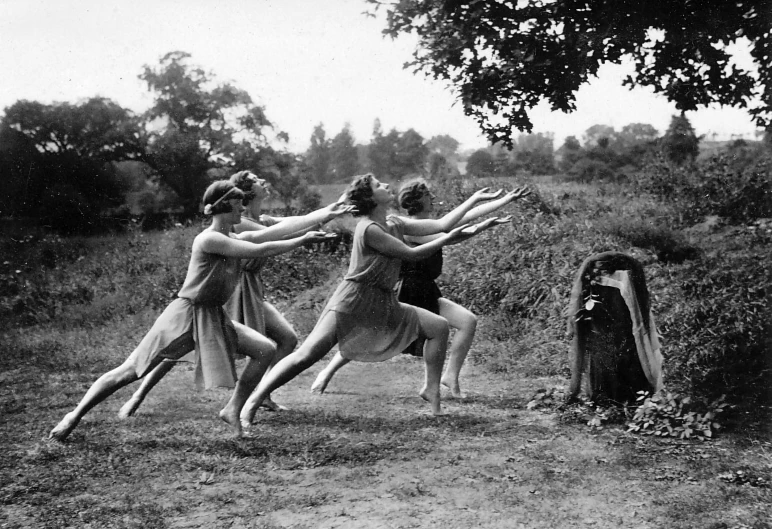 a group of women standing on top of a grass covered field, by Gertrude Greene, flickr, art nouveau, modern dance aesthetic, ritual in a forest, classic dancer striking a pose, snapchat photo