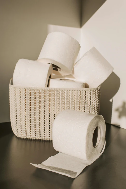 a basket filled with rolls of toilet paper, by Jessie Algie, pexels contest winner, conceptual art, white ceramic shapes, ivory, official product photo, natural soft light