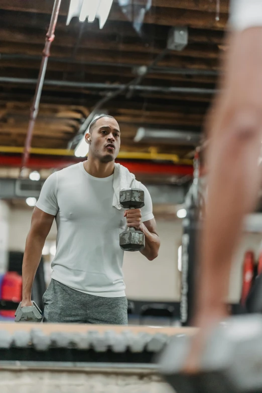 a man holding a water bottle while standing in a gym, pexels contest winner, happening, lifting weights, gif, kai carpenter, ca