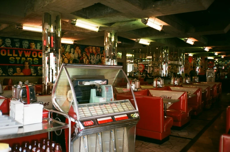 a juke box sitting inside of a diner, an album cover, unsplash, atomic age maximalist, 2000s photo, elvis, 1990's photo