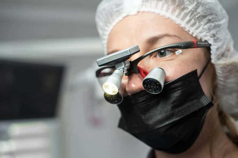 a close up of a person wearing a face mask, a picture, surgical implements, zeiss lenses, sublighting, thumbnail