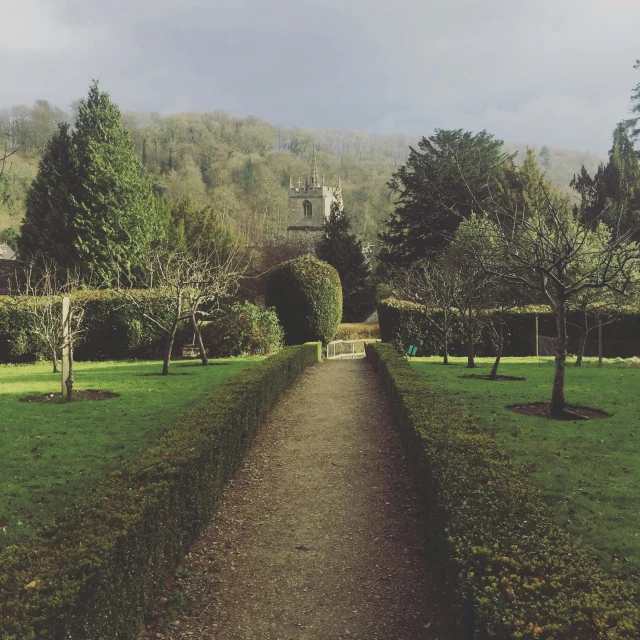 a path in the middle of a lush green park, inspired by Thomas Struth, pexels contest winner, old abbey in the background, february), lovely valley, hedge