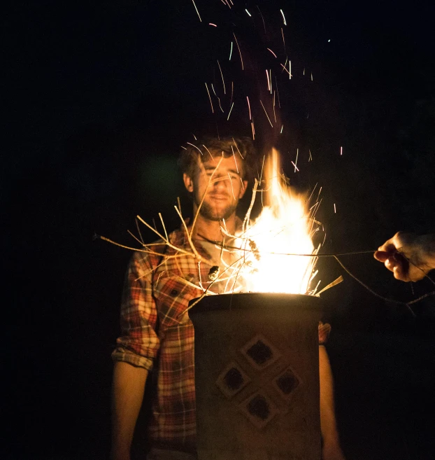 a man that is standing in front of a fire, by Matt Cavotta, fourth of july, stick and poke, outside lighting, avatar image