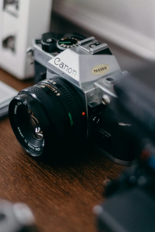 a camera sitting on top of a wooden table, by Adam Marczyński, unsplash contest winner, photorealism, 1 9 8 0 s analog video, playful composition canon, high angle close up shot, today\'s featured photograph 4k