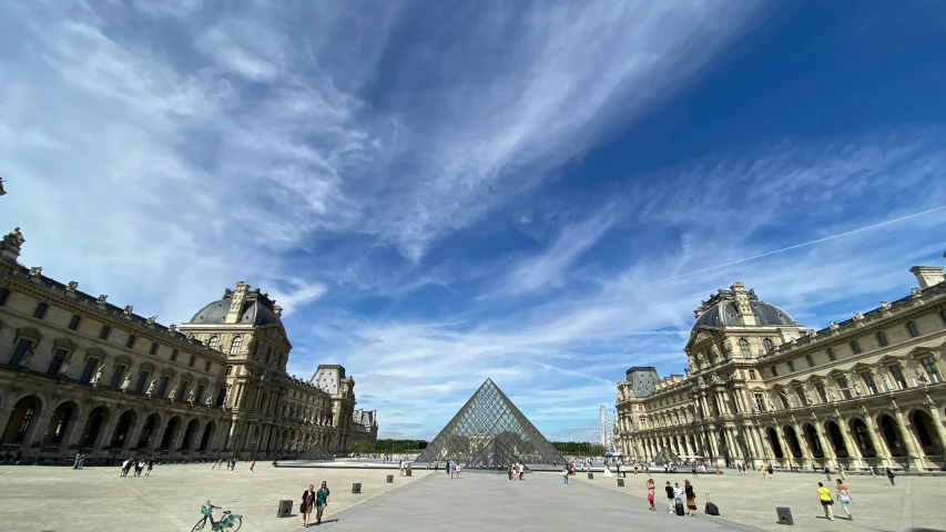 a group of people walking around a courtyard, an album cover, pexels contest winner, neoclassicism, from louvre, clear blue skies, wide angle exterior 2022, pyramid