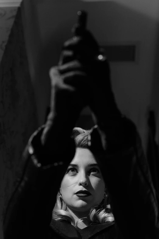 a black and white photo of a woman holding a gun, a black and white photo, by Alexis Grimou, a portrait of lana del rey, mirror selfie, florence pugh, dark photography