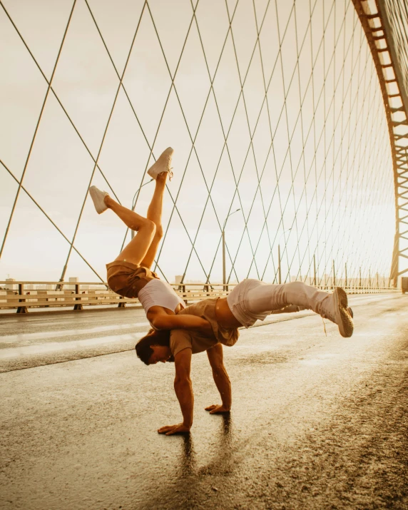 two people doing a handstand on a bridge, pexels contest winner, arabesque, gay pride, profile image, sweaty, capoeira