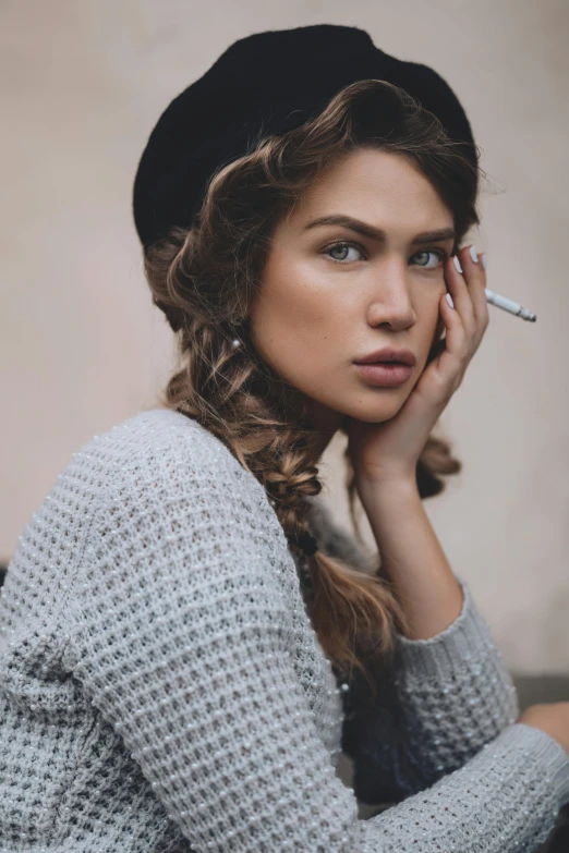 a woman sitting on a bench smoking a cigarette, inspired by Elsa Bleda, trending on pexels, art nouveau, woman with braided brown hair, wearing a beret, perfect face model, grey tones