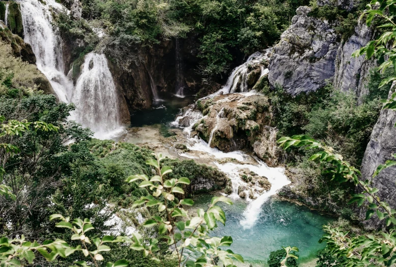 a waterfall in the middle of a lush green forest, by Emma Andijewska, pexels contest winner, hurufiyya, turquoise water, terraced orchards and ponds, 90s photo, high quality product image”