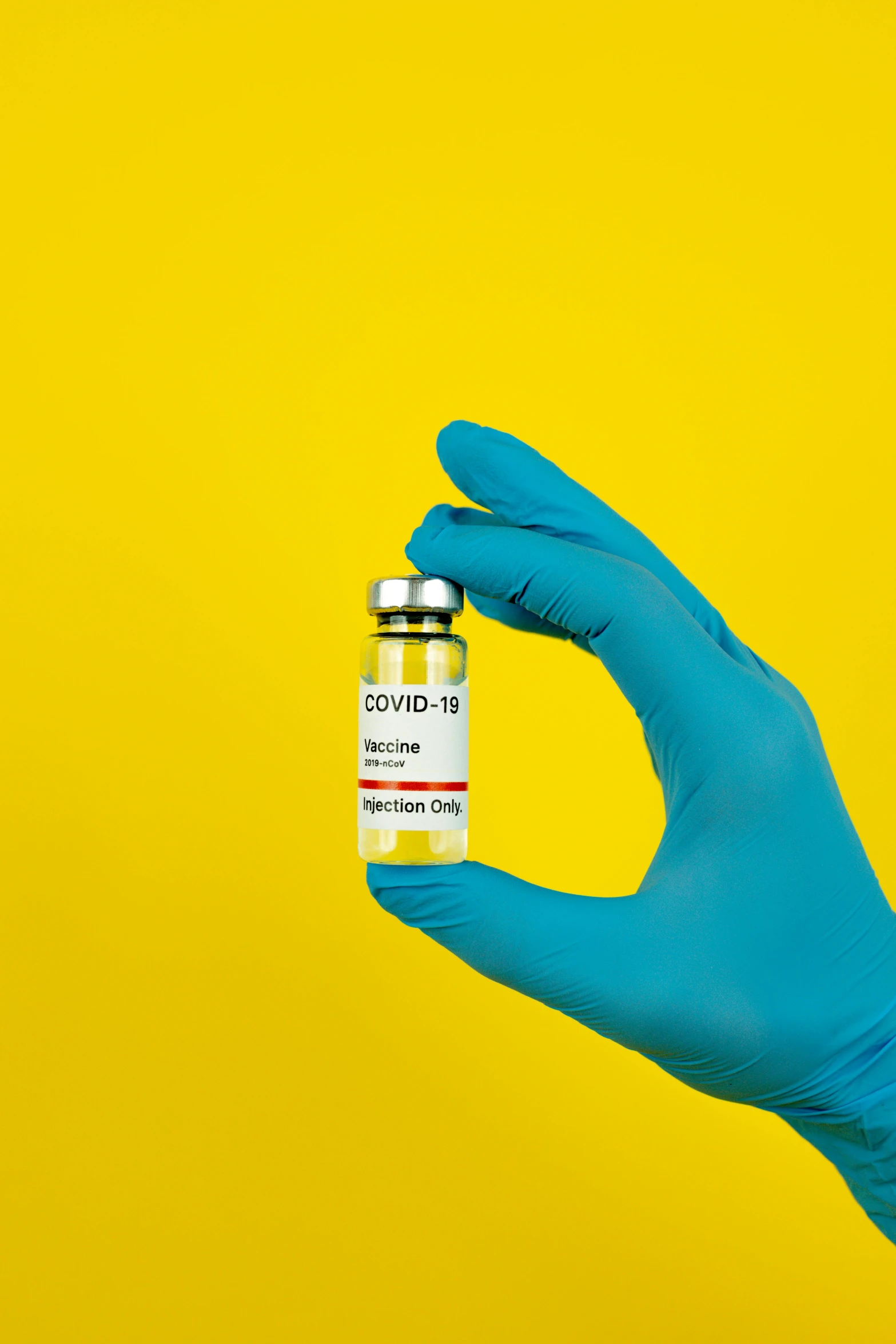 a gloved hand holding a vial of covidid, by artist, shutterstock, instagram photo, yellow, steroid use, centered shot