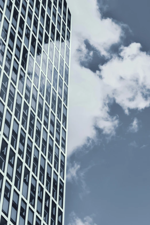 a black and white photo of a tall building, pexels contest winner, light blue sky with clouds, prize winning color photo, thumbnail, glass windows