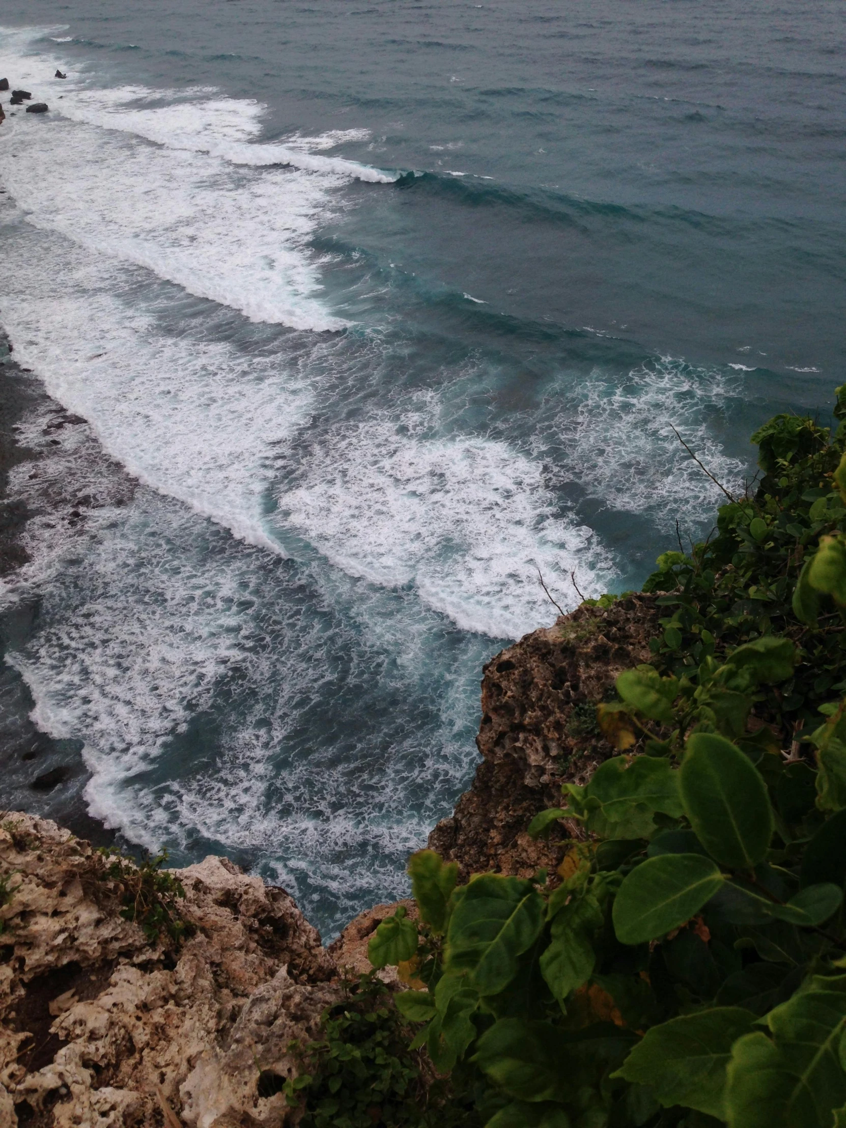 a view of the ocean from the top of a cliff, happening, curls, bali, up close, slide show