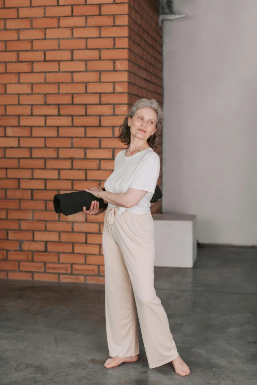 a woman standing in front of a brick wall, off - white style, elderly, holster, jovana rikalo