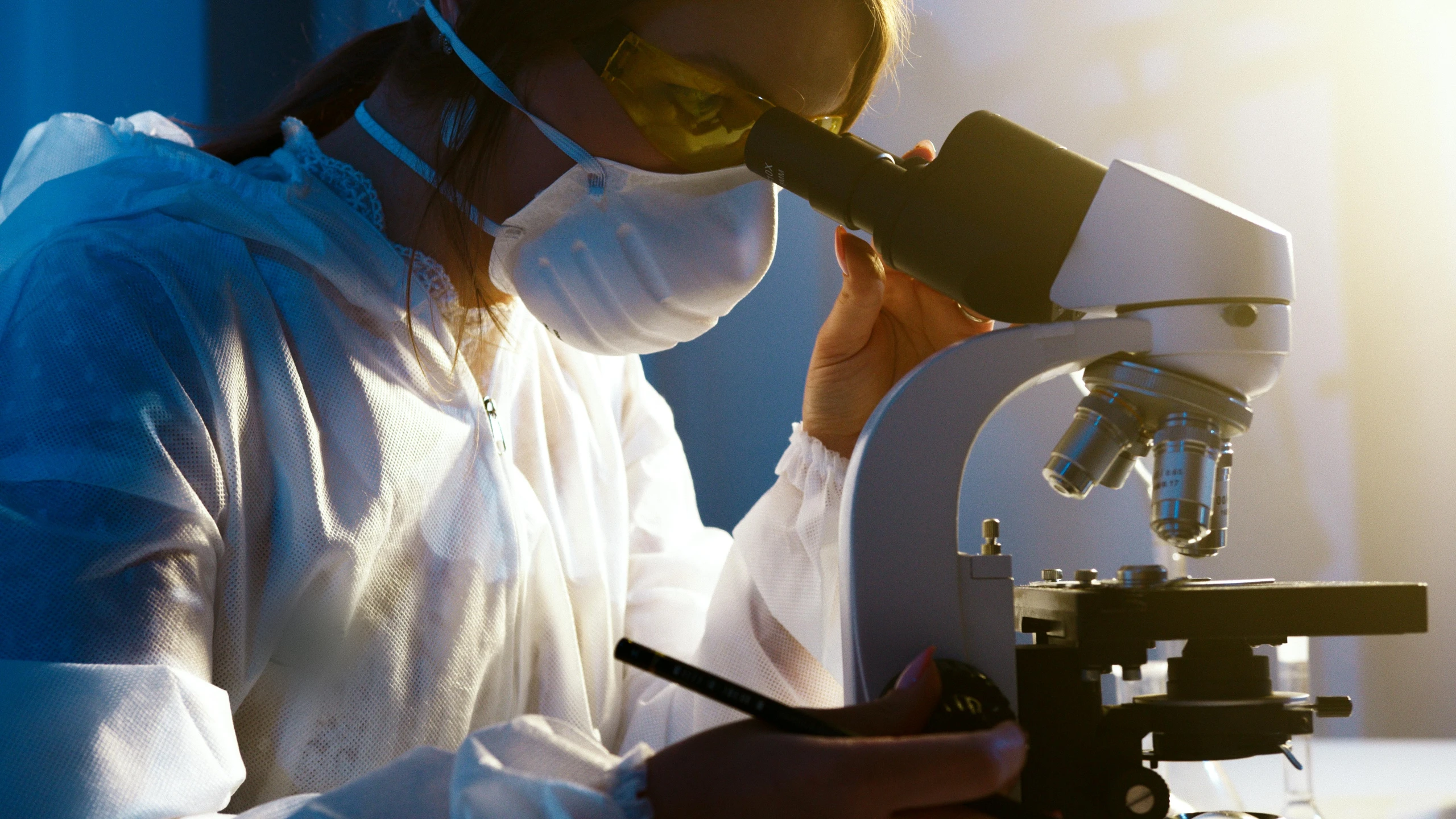 a woman in a lab coat looking through a microscope, a microscopic photo, shutterstock, instagram photo, worksafe. cinematic, thumbnail, underground lab