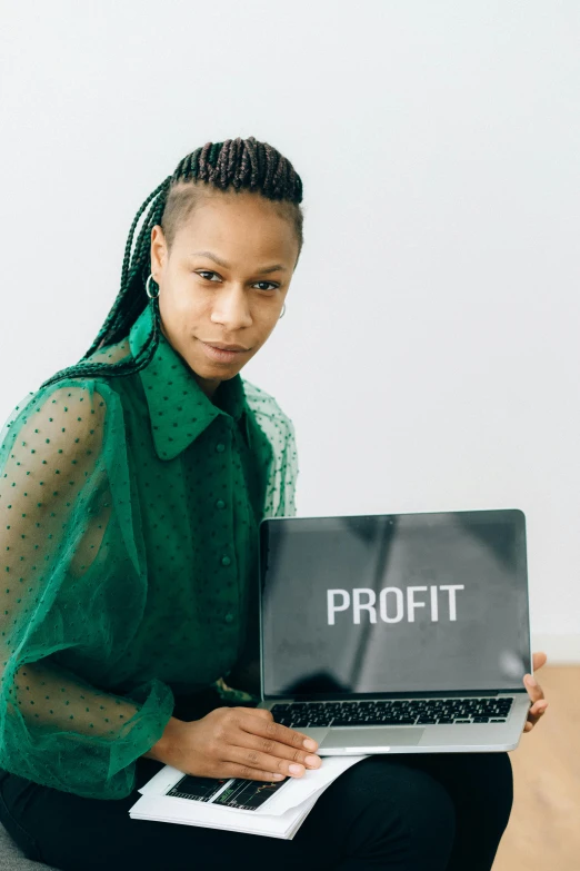 a woman holding a laptop with the word profit on it, afrofuturism, profile picture, lpoty, wearing business casual dress, thumbnail