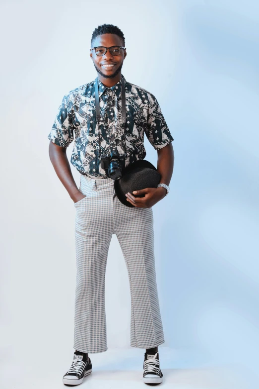 a man standing with his hands in his pockets, an album cover, inspired by Paul Georges, trending on pexels, patterned clothing, at a fashion shoot, silver and cool colors, 7 0 s vibe