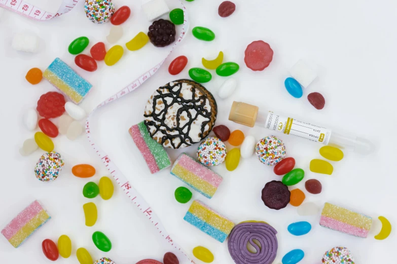 a donut sitting on top of a pile of candy, a picture, inspired by Damien Hirst, trending on pexels, product view, plexus, full body image, made of candy and lollypops