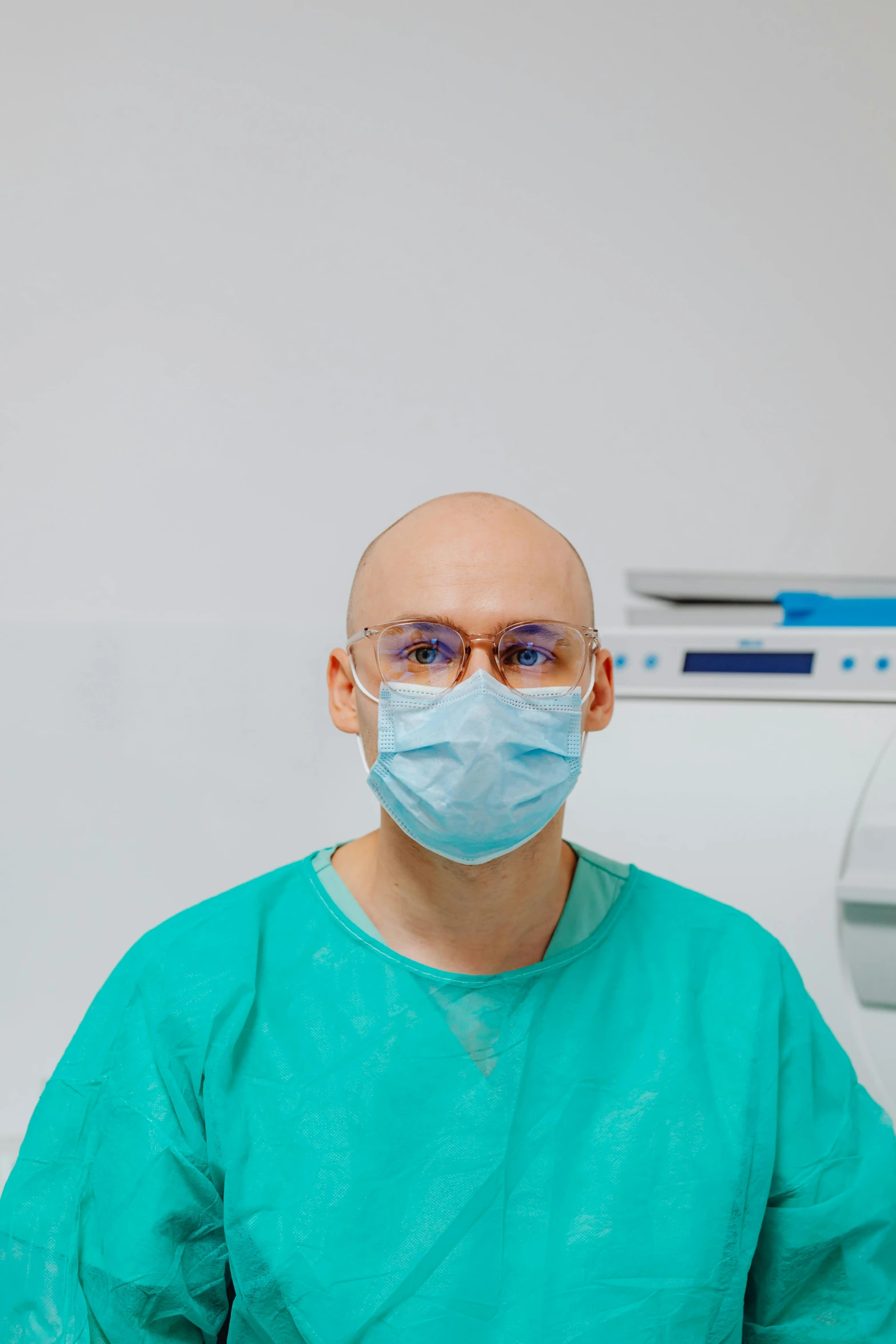 a man sitting in a chair wearing a surgical mask, by Adam Marczyński, surgery theatre, avatar image, bald, dentist
