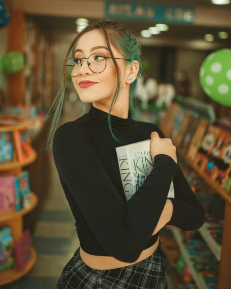 a woman wearing glasses standing in a store, a character portrait, by Julia Pishtar, trending on pexels, holding books, green hair, young beautiful amouranth, physical : tinyest midriff ever