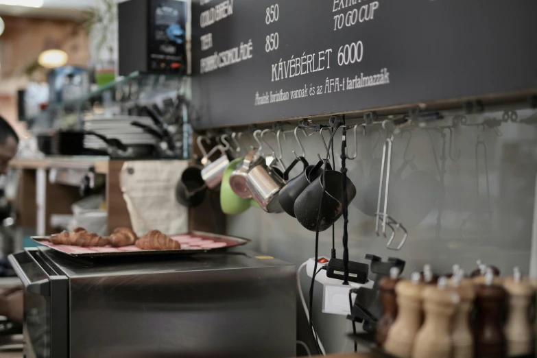 a close up of a plate of food on a counter, a photo, arbeitsrat für kunst, kettle, hanging, at checkout, unblur