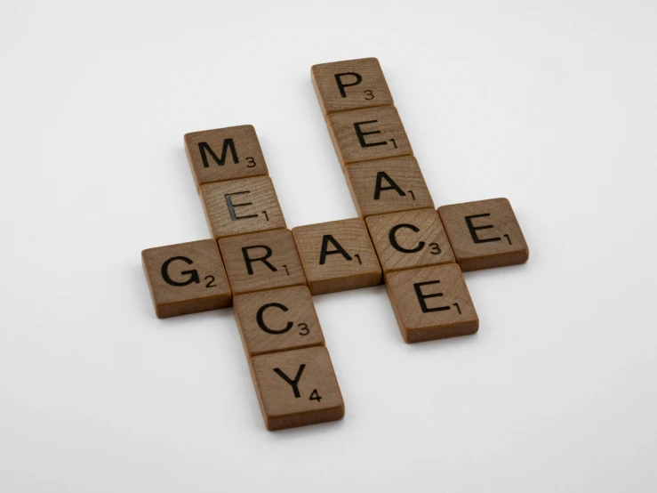 a cross made out of scrabbles on a white surface, an album cover, by Grace Clements, pexels, renaissance, mercy ( overwatch ), peace, medium format, desktop wallpaper