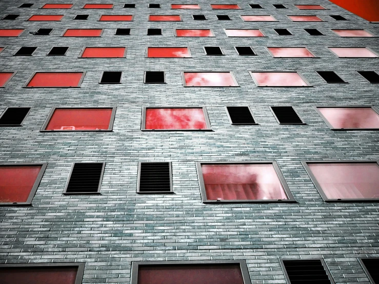 a tall brick building with lots of windows, an album cover, inspired by Andreas Gursky, pexels contest winner, brutalism, red selective coloring, little windows, pink, red and grey only