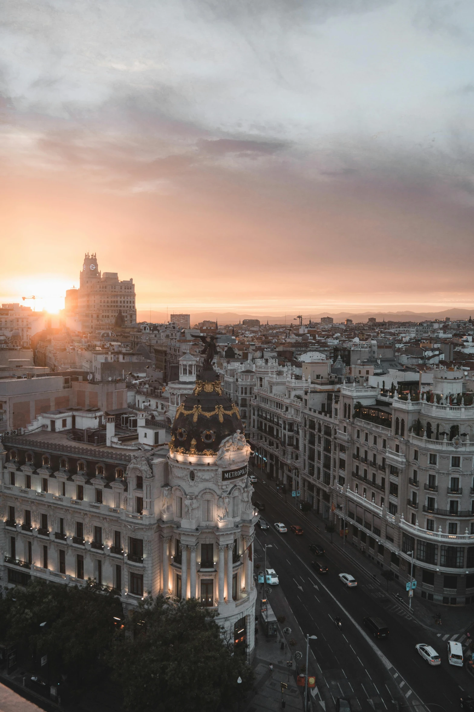 a view of a city from the top of a building, by Luis Molinari, square, sun set, spanish, high res 8k